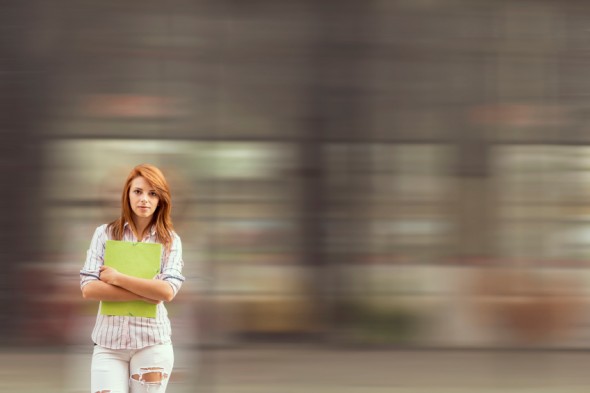 Young business woman standing in front of an office building